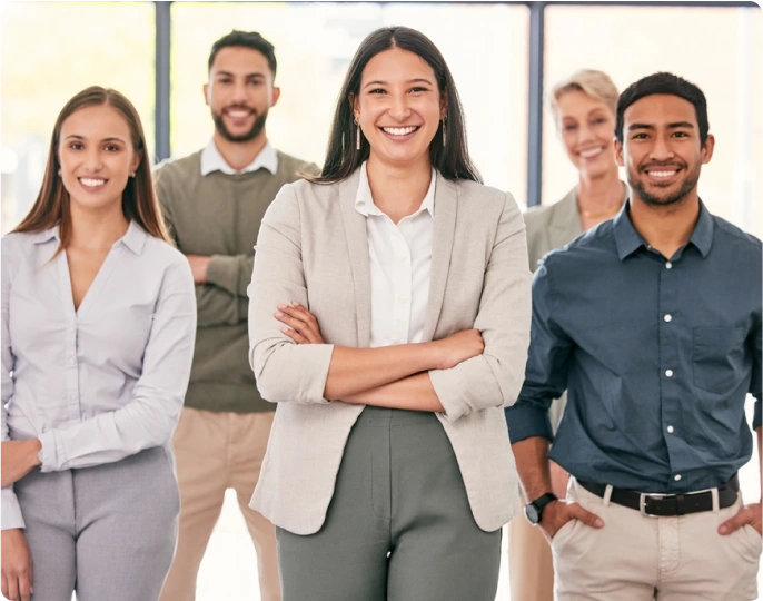 Smiling team of diverse professionals standing together in an office, representing the friendly and experienced staff at Build CPA.